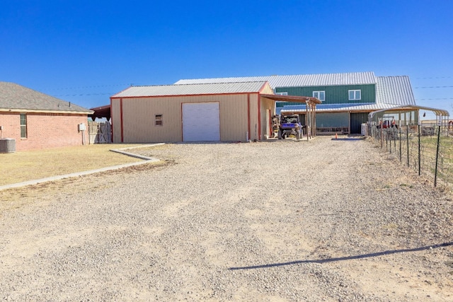 view of outdoor structure featuring a carport and a garage