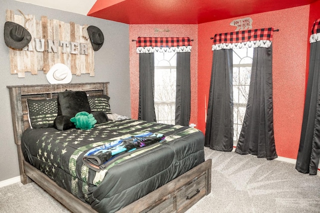 carpeted bedroom featuring multiple windows