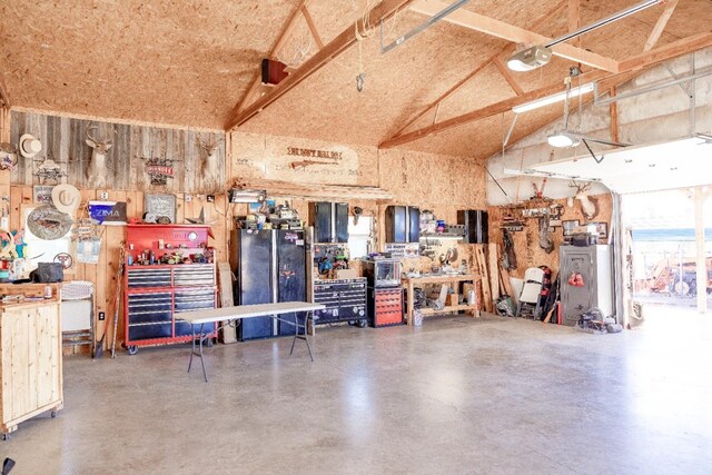 garage with a garage door opener and a workshop area