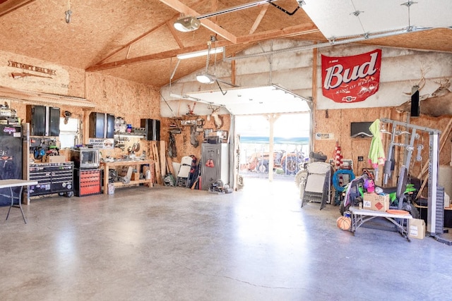 garage with a garage door opener and a workshop area