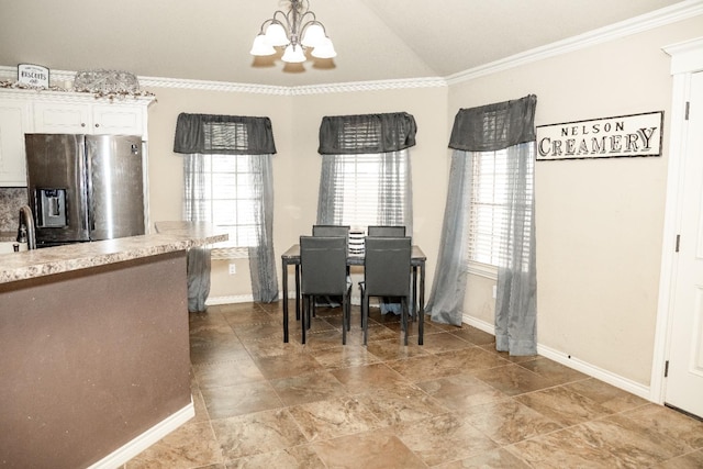 dining room featuring lofted ceiling, ornamental molding, a chandelier, and a wealth of natural light