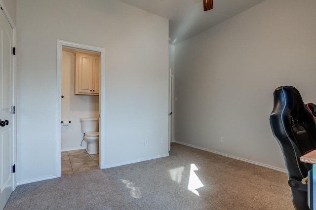 unfurnished office featuring ceiling fan and light colored carpet