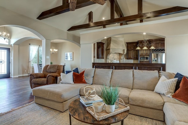 living room featuring an inviting chandelier, high vaulted ceiling, beam ceiling, and light hardwood / wood-style floors