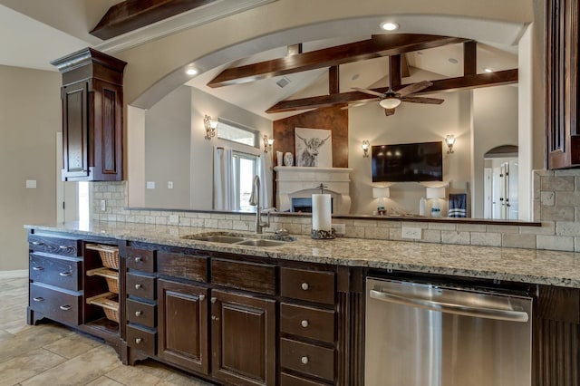 kitchen featuring light stone counters, dishwasher, sink, and dark brown cabinets