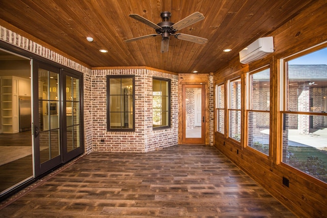 unfurnished sunroom featuring a ceiling fan, wood ceiling, a wall unit AC, and french doors