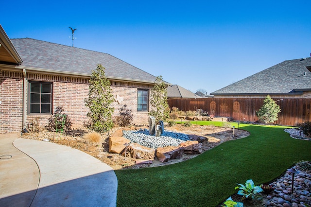 view of yard with a fenced backyard