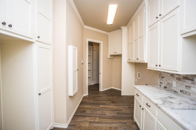 kitchen featuring dark wood-style flooring, crown molding, decorative backsplash, white cabinets, and light stone countertops