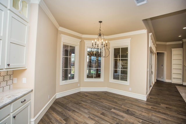 unfurnished dining area featuring baseboards, visible vents, dark wood-type flooring, and ornamental molding