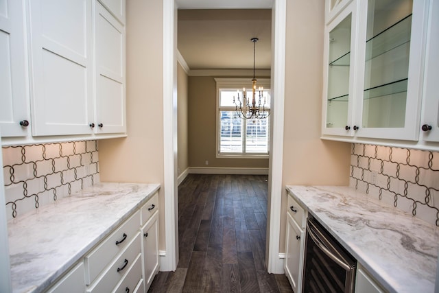 kitchen featuring white cabinetry, wine cooler, glass insert cabinets, and pendant lighting