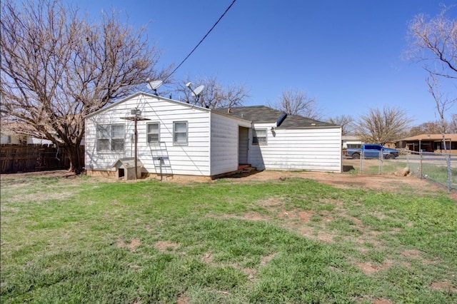 back of property featuring a yard