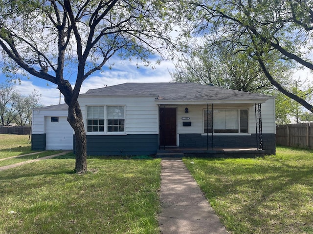 view of front of home featuring a garage and a front lawn