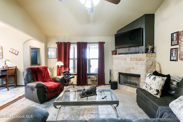 10018 Ave X, Lubbock, TX 79423 - living area with lofted ceiling, a ceiling fan, a stone fireplace, carpet flooring, and arched walkways