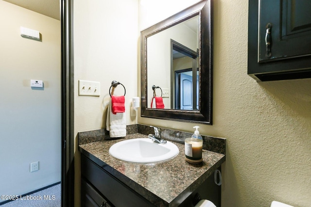 10018 Ave X, Lubbock, TX 79423 - bathroom with vanity and a textured wall