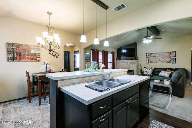10018 Ave X, Lubbock, TX 79423 - kitchen with light countertops, a sink, open floor plan, a chandelier, and a center island with sink