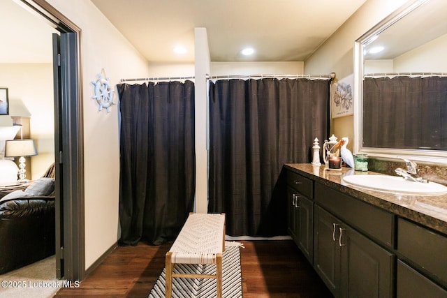 10018 Ave X, Lubbock, TX 79423 - full bath featuring vanity, wood finished floors, and connected bathroom