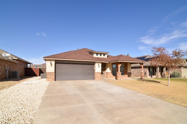 view of front facade with a garage and central AC