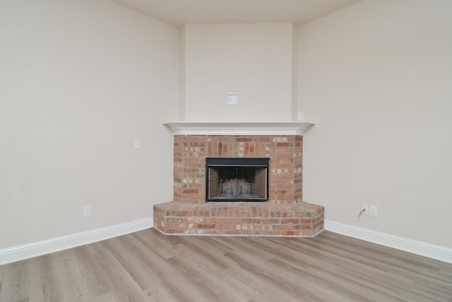 unfurnished living room with a fireplace and light hardwood / wood-style flooring