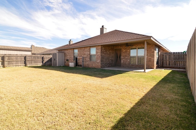 back of property with a yard and a patio area