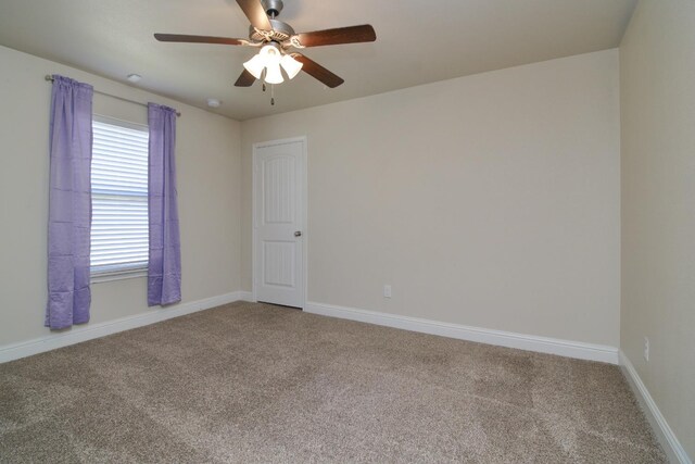 spare room featuring carpet flooring and ceiling fan