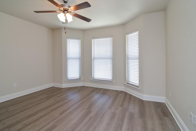 spare room featuring ceiling fan and light wood-type flooring