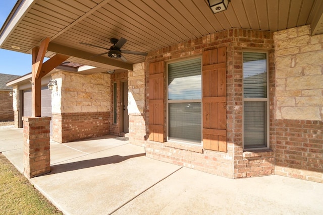 view of patio / terrace with a garage and ceiling fan