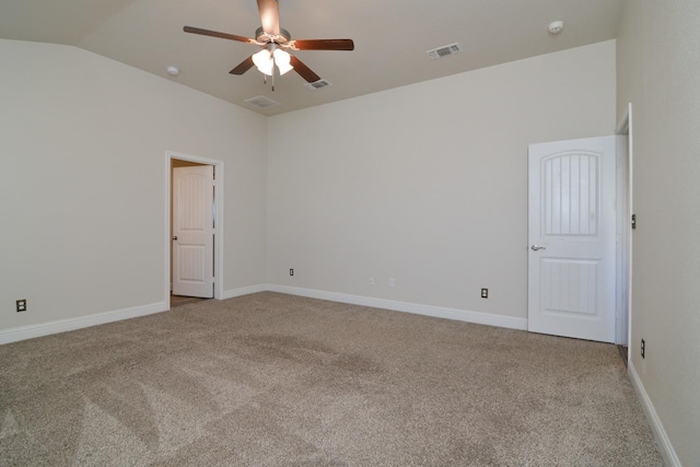 carpeted spare room with ceiling fan and lofted ceiling