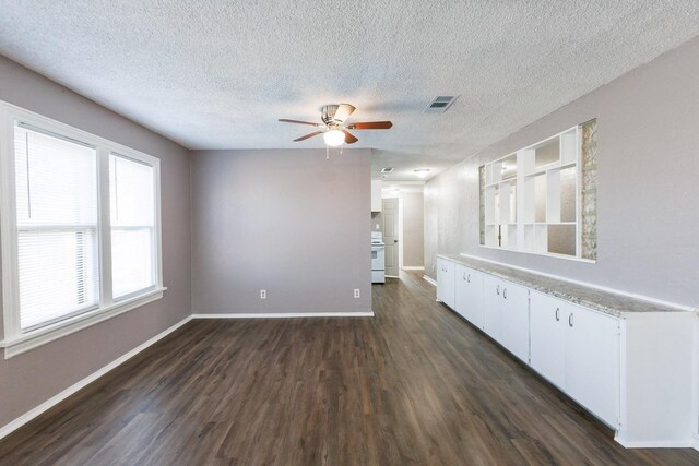 interior space with dark wood-type flooring, a textured ceiling, and ceiling fan