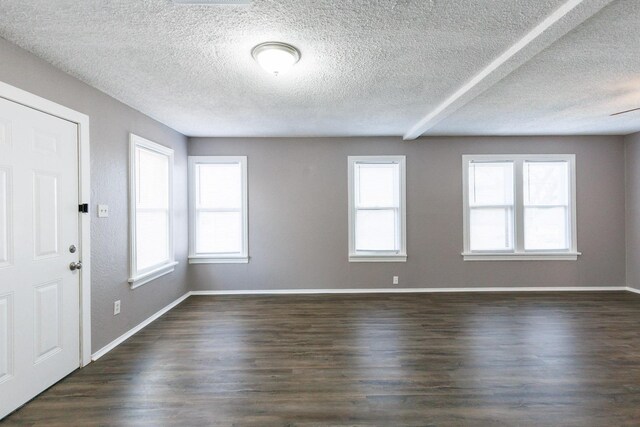 foyer featuring dark wood-type flooring and a textured ceiling