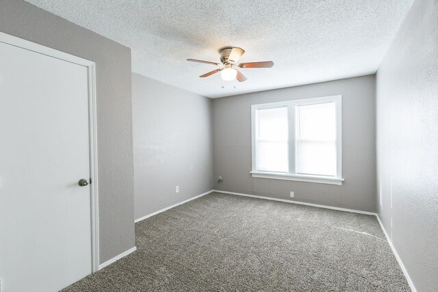 empty room featuring carpet flooring, a textured ceiling, and ceiling fan