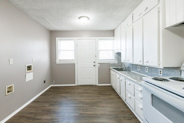 kitchen with white cabinets, dark hardwood / wood-style floors, and electric range