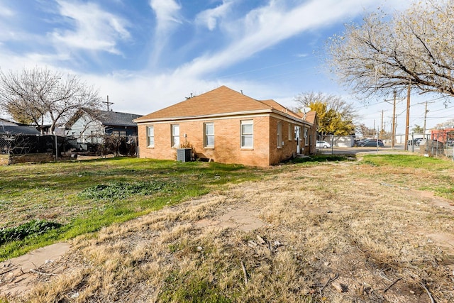 rear view of property with central AC unit