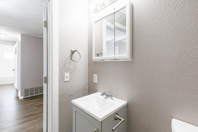 bathroom featuring vanity and hardwood / wood-style floors