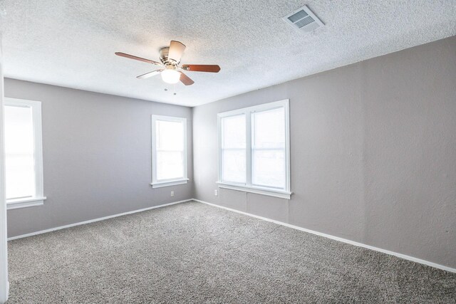 carpeted empty room featuring a textured ceiling and ceiling fan