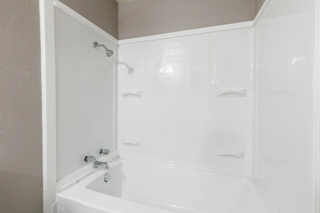 bathroom with shower / washtub combination