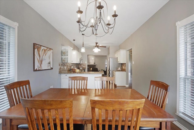 dining room with ceiling fan and lofted ceiling