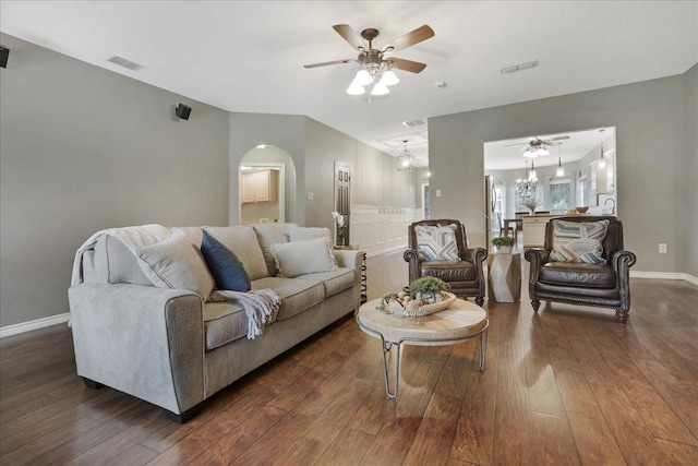 living room featuring ceiling fan and dark hardwood / wood-style floors