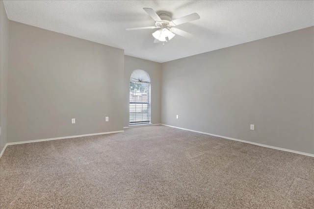 spare room featuring carpet floors, a textured ceiling, and ceiling fan