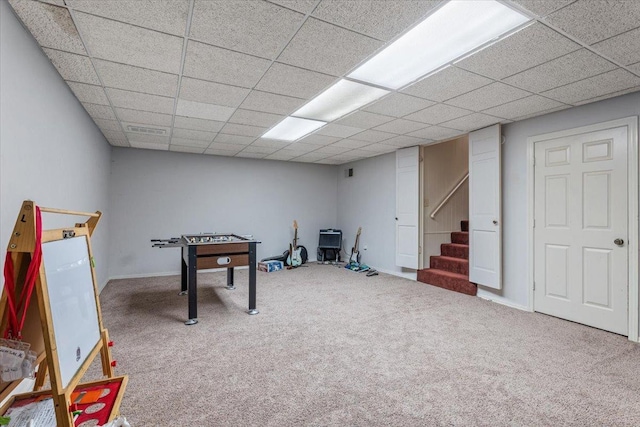 game room featuring carpet and a drop ceiling