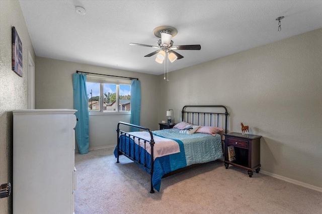 bedroom with light carpet and ceiling fan