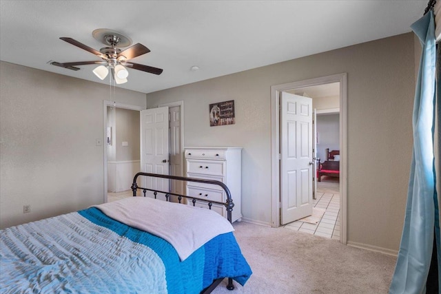 bedroom with light colored carpet and ceiling fan