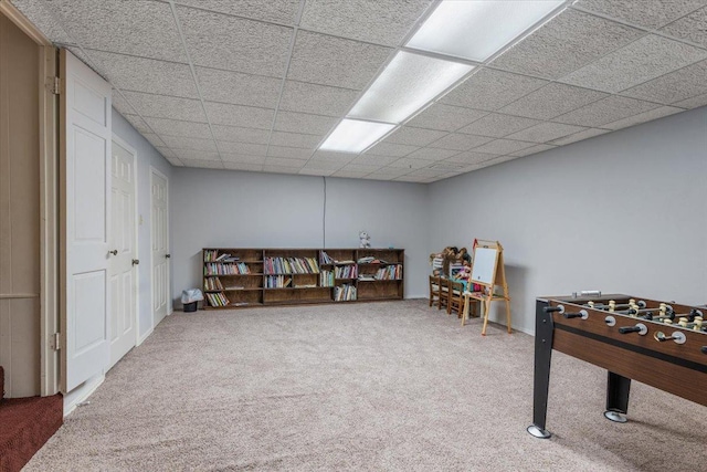 game room featuring a paneled ceiling and carpet flooring