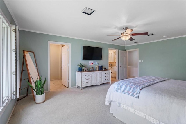 carpeted bedroom featuring ensuite bathroom, ornamental molding, and ceiling fan