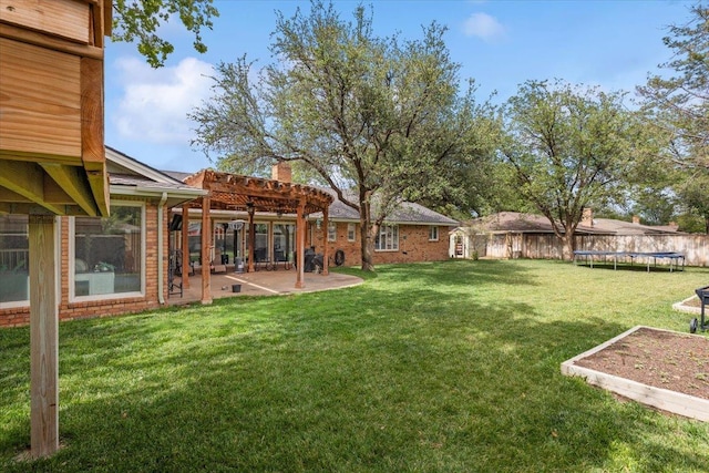 view of yard with a trampoline and a patio area