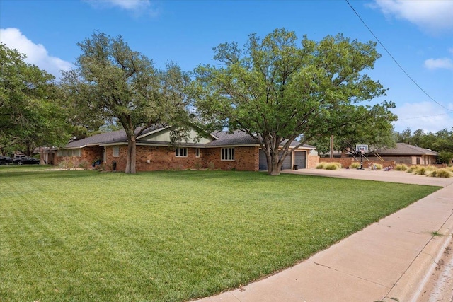 ranch-style house featuring a garage and a front yard