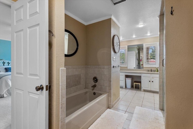 bathroom with vanity, ornamental molding, tile patterned floors, and a tub