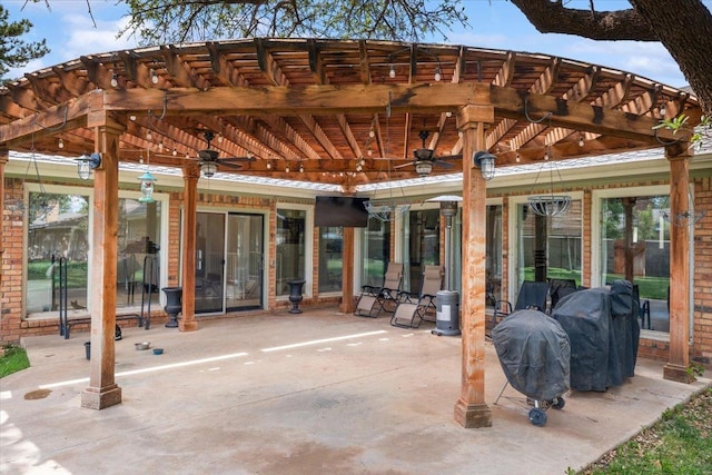 view of patio featuring area for grilling, ceiling fan, and a pergola