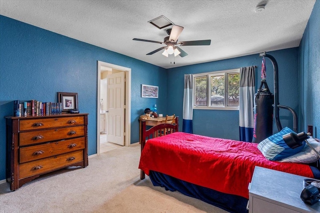 carpeted bedroom with ceiling fan, a textured ceiling, and ensuite bath