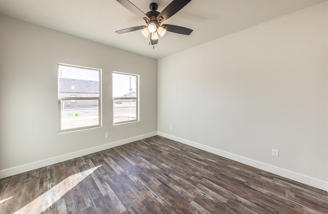 unfurnished room featuring dark wood-type flooring and ceiling fan