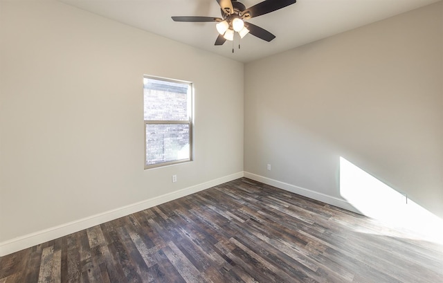 spare room with dark wood-type flooring and ceiling fan