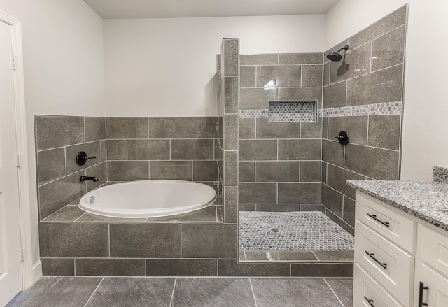 bathroom featuring vanity and independent shower and bath